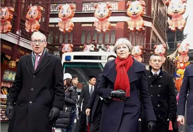  ?? — Reuters ?? Taking in the sights: May and her husband Philip (left) ushering in the year of the dog while visiting Yu Yuan Garden in Shanghai.