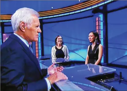  ??  ?? Alex Trebek talks to the contestant­s on the TV show Jeopardy right after Final Jeopardy. Rebecca Zoshak, far left, a Great Valley High School graduate, competed on Thursday night.