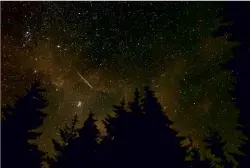  ?? ?? TOP: A meteor streaks across the sky in Spruce Knob, West Virginia, during the annual Perseid meteor shower on 11 August. ABOVE: The meteorite that crashed through Ruth Hamilton’s bedroom ceiling... RIGHT: And where it landed while Ruth was sleeping.