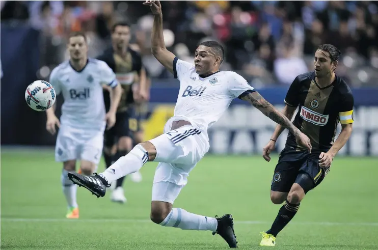  ?? — THE CANADIAN PRESS ?? The Whitecaps’ Christian Dean kicks the ball away from Philadelph­ia’s Alejandro Bedoya during the teams’ scoreless tie Sunday night at B.C. Place Stadium.