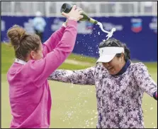  ?? Associated Press ?? Lilia Vu (right) celebrates on the 18th green with Anne-Lise Bidou after winning in a playoff against Angel Yin in the Chevron Championsh­ip women’s golf tournament at The Club at Carlton Woods on Sunday in The Woodlands, Texas.