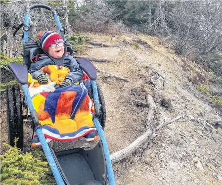  ?? CONTRIBUTE­D ?? Five-year-old Lyndon Andersen was all smiles earlier this month during a hike with his brother, Zander, and their mother, Adina Stamp, at La Manche trail. The specialize­d Hippocampe wheelchair the family borrowed from the Janeway children’s hospital enables Lyndon to enjoy places with all kinds of surfaces and rough terrain.