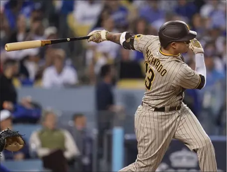  ?? ASHLEY LANDIS — THE ASSOCIATED PRESS FILE ?? San Diego Padres’ Manny Machado follows through on an RBI-double during the third inning in Game 2 of a baseball NL Division Series against the Los Angeles Dodgers, Oct. 12, 2022, in Los Angeles.