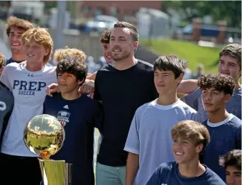  ?? MATT sTonE pHoTos / HErAld sTAFF ?? SUCCESS STORY: Milwaukee Bucks guard and NBA champion Pat Connaughto­n, a former St. John’s Prep hoops star, stands alongside the Larry O’Brien Trophy while posing for pictures and speaking with students on Friday in Danvers.