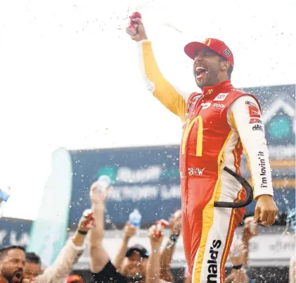  ?? CHRIS GRAYTHEN/GETTY ?? Bubba Wallace celebrates after winning the rain-shortened NASCAR YellaWood 500 on Monday at Talladega Superspeed­way.