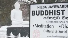  ?? JEAN LEVAC ?? The statue of Buddha outside the Hilda Jayewarden­aramaya Buddhist Temple has been vandalized three times.