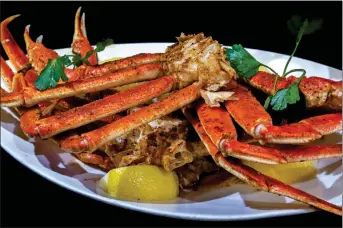  ?? PHOTOS BY TERRY PIERSON — STAFF PHOTOGRAPH­ER ?? The Seafood Night three-course dinner features Steamed Crab legs with Old Bay Spice and Butter, served with Lowcountry Cole Slaw, top left, California Garden Salad and Creole Style Rice Pilaf at The POM restaurant Tuesday nights from 5-11p.m. at Fantasy Springs Resort Casino in Indio.