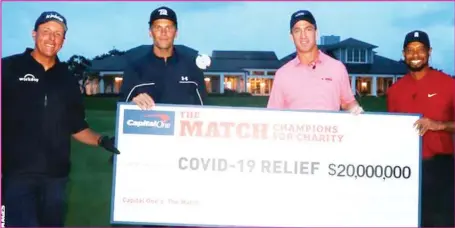  ??  ?? R-L: Tiger Woods and Peyton Manning celebrate defeating Tom Brady and Phil Michelson in The Match golf contest that fetched $20million for Covid-19 relief in Florida, USA