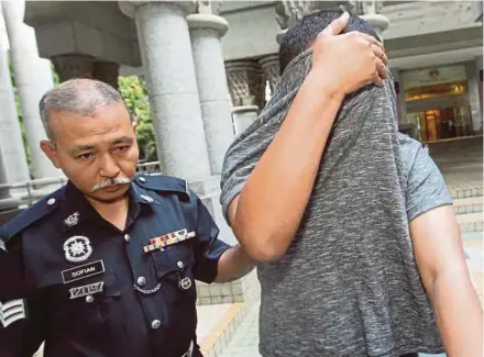  ?? PIC BY MOHD FADLI HAMZAH ?? The suspect being taken to the Special Court for Sexual Crimes Against Children in Putrajaya yesterday.