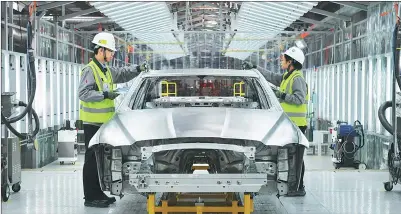  ?? PHOTOS PROVIDED TO CHINA DAILY ?? Workers examine a car at the welding workshop of Chery Jaguar Land Rover Automotive’s plant in Changshu, Jiangsu province.