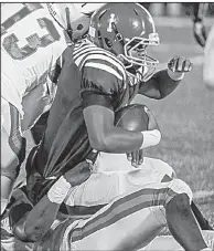  ?? Arkansas Democrat-Gazette/MITCHELL PE MASILUN ?? West Memphis quarterbac­k Tyler Foots (1) gets sacked by Pine Bluff defensive end Verndarius Hodges on Friday in Pine Bluff. The Zebras defeated the Blue Devils 33-7.
