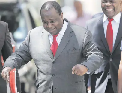  ?? Picture: EPA-EFE ?? EGG DANCE. Finance Minister Tito Mboweni arrives to deliver the mid-term budget statement at parliament in Cape Town yesterday.