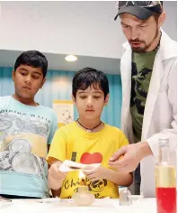  ??  ?? MAGIC FIRE... Kids learn how to read secret messages written using a special ink that used during the world war times.