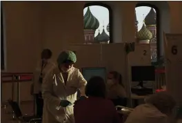  ?? PAVEL GOLOVKIN — THE ASSOCIATED PRESS ?? A medical worker administer­s a shot of Russia’s Sputnik Lite coronaviru­s vaccine at a vaccinatio­n center in the GUM State Department store in Red Square with the St. Basil Cathedral in the background in Moscow, Russia, on Tuesday.