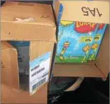  ?? KATHLEEN E. CAREY — DIGITAL FIRST MEDIA ?? Copies of “The Lorax” are loaded to Washington Monday to deliver in a Ford C-Max headed to Senators’ offices.