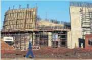  ?? Christians/Sunday Times /Shelley ?? NHI under constructi­on: Workers help to construct a new hospital in De Aar, which forms part of the NHI’s initiative­s.