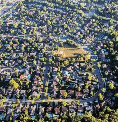  ?? JAMES MACDONALD / BLOOMBERG FILES ?? An aerial photograph of a Toronto housing developmen­t. New mortgage rules have taken a 16-per-cent bite out of millennial­s’ homebuying power.