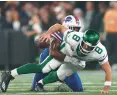  ?? ELSA/GETTY ?? Jets quarterbac­k Aaron Rodgers is sacked by Bills defensive end Leonard Floyd on Monday at Metlife Stadium in East Rutherford, New Jersey.