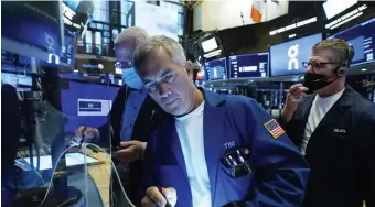  ?? AP FILE ?? BIGGEST STRENGTH OR RISK? Trader Timothy Nick, center, works on the floor of the New York Stock Exchange on Sept. 15