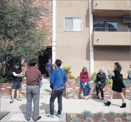  ?? Patrick T. Fallon For The Times ?? PEOPLE wait to tour a condo for sale on South Bentley Avenue in L.A. The city’s attractive­ness has created a housing affordabil­ity crisis with no end in sight.