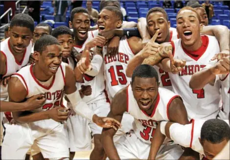  ?? KEITH SRAKOCIC - ASSOCIATED PRESS FILE ?? The Imhotep Charter boys basketball team, pictured after winning a PIAA championsh­ip in 2011, has been the most successful charter school sports team with six state titles. Charter schools are an added wrinkle in the debate between public and private...