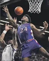  ?? Charlie Riedel Associated Press ?? KANSAS FORWARD KJ Adams Jr. puts up a shot as Kansas State forward Keyontae Johnson defends.