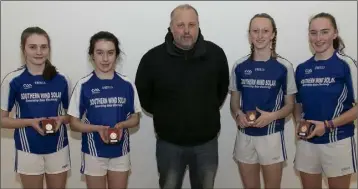  ??  ?? Official Alan O’Neill with the women’s Junior ‘C’ doubles finalists which was an all-Ballymitty encounter, with Danielle Kinsella and Becky O’Neill (left) losing to Niamh Millar and April Moran (right).