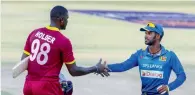  ?? AFP ?? Lanka captain Upul Tharanga (right) shakes hands with West Indies’ Jason Holder after winning the fifth match. —