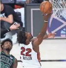  ?? KIM KLEMENT/USA TODAY SPORTS ?? Heat forward Jimmy Butler goes up for a shot past Celtics guard Marcus Smart at ESPN Wide World of Sports Complex on Tuesday.