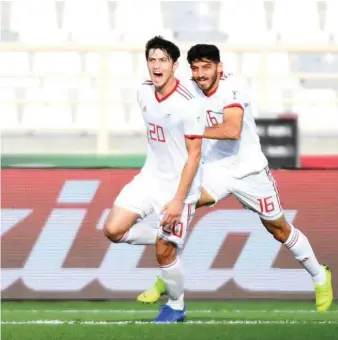  ?? (AFP) ?? Iran forward Sardar Azmoun (left) celebrates his goal during the 2019 AFC Asian Cup group D match against Vietnam in Abu Dhabi yesterday.