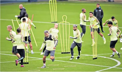  ??  ?? Running men: Nicolas Otamendi and Sergio Aguero lead training for Manchester City’s Champions League match