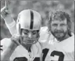  ??  ?? Fred Biletnikof­f, left, and quarterbac­k Ken Stabler of the Oakland Raiders proudly hold up one finger, indicating their team as the NFL’s best after defeating the Minnesota Vikings in Super Bowl XI, 41 years ago today.