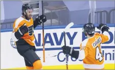  ?? COLE BURSTON — THE CANADIAN PRESS VIA AP ?? Flyers center Kevin Hayes (13) celebrates his goal with left wing Joel Farabee (49) during the first period.