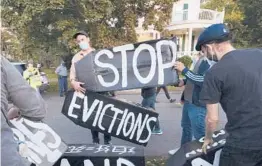  ?? MICHAEL DWYER/AP 2020 ?? Activists erect a sign in front of Massachuse­tts Gov. Charlie Baker’s house in Swampscott. Advocates blast that state’s rental assistance applicatio­n process.