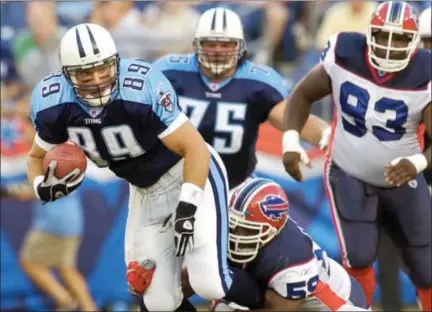  ?? MARK HUMPHREY — THE ASSOCIATED PRESS FILE ?? FILE- In this file photo, Tennessee Titans wide receiver Frank Wycheck (89) is brought down by Buffalo Bills linebacker London Fletcher (59) on the first play from scrimmage in the first quarter of their preseason game in Nashville, Tenn. Wycheck says...