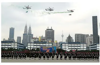  ??  ?? Rapt attention: Three police helicopter­s performing a flyby during the 212th Police Day celebratio­ns at Pulapol.