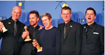  ??  ?? Best Screenplay winner writer-director Martin McDonagh, Best Supporting Actor Sam Rockwell and Best Actress in a motion picture drama Frances McDormand for their film “Three Billboards Outside Ebbing, Missouri,” pose with their fellow cast and crew.