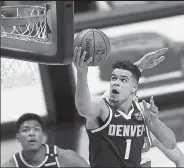  ?? Matthew Stockman / Getty Images ?? The Nuggets’ Michael Porter Jr. goes up for a shot against the Wizards during the second quarter of Thursday night’s game at Ball Arena in Denver.