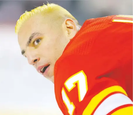  ?? AL CHAREST ?? Milan Lucic sported his bleached ’do during a warm-up before the Flames’ New Year’s Eve home game against the Chicago Blackhawks.
