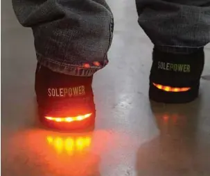  ?? Rebecca Droke photos / Post-Gazette ?? SolePower shoes harness the kinetic energy from walking to charge batteries and power electronic devices, including lights on industrial boots at the Tech Shop in Pittsburgh’s East Liberty neighborho­od.