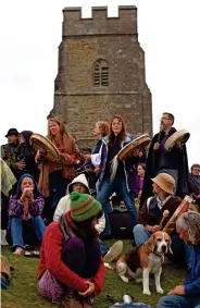  ??  ?? Spiritual: Visitors flock to Glastonbur­y Tor before the bongo busker brought discord
