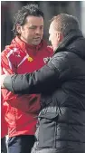  ??  ?? Managers Paul Hartley and Brendan Rodgers embrace after the fulltime whistle.