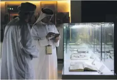  ?? Pawan Singh / The National ?? Top, the First Atlas illustrate­d with woodcut maps at the Manuscript­s Conference at Manarat Al Saadiyat in Abu Dhabi. Above left, more and more Emiratis are interested in manuscript­s and rare books; right, an historic book from Petrus Apianus