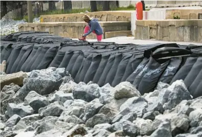  ?? JOSE M. OSORIO/CHICAGO TRIBUNE ?? Large sandbags line the Lakefront Trail near Fullerton Avenue in Chicago on May 24.