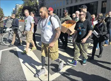  ?? Ricky Carioti Washington Post/Getty Images ?? MANY VETERANS rely on pot to help treat post-traumatic stress disorder, chronic pain and opioid addiction. Above, Jose Martinez of L.A., center, marches in Washington in support of medical marijuana in 2015.