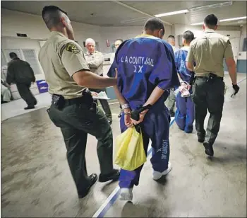  ?? Photograph­s by Al Seib Los Angeles Times ?? L.A. COUNTY sheriff ’s deputies move inmates through the Men’s Central Jail. Sheriff Alex Villanueva campaigned on a vow to eject immigratio­n agents from jails, but some advocates want him to go further.