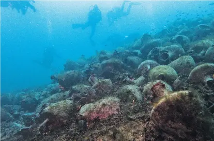  ?? ELENA BECATOROS/ASSOCIATED PRESS ?? Divers visit a shipwreck from the fifth century B.C. near the coast of Peristera, Greece, the first ancient shipwreck to be opened to the public in Greece, including to recreation­al divers who will be able to visit the wreck itself.