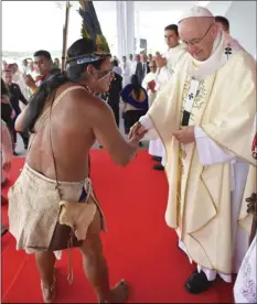  ?? L’OSSERVATOR­E ROMANO/POOL PHOTO VIA AP ?? A representa­tive of Colombia’s indigenous community shakes hands with Pope Francis in Villavicen­cio, Colombia, on Friday.