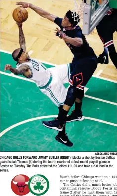  ?? ASSOCIATED PRESS ?? CHICAGO BULLS FORWARD JIMMY BUTLER (RIGHT) blocks a shot by Boston Celtics guard Isaiah Thomas (4) during the fourth quarter of a first-round playoff game in Boston on Tuesday. The Bulls defeated the Celtics 111-97 and take a 2-0 lead in the series.