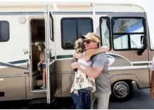  ?? ?? Faircloth hugs Sheri Roen as her family donates their motorhome to Emergencyr­v.org on Sept. 5 in Sierra County, Calif. Accompanie­d by daughter Luna, left, Faircloth delivered it to the Prices, Dixie fire victims, later that day.